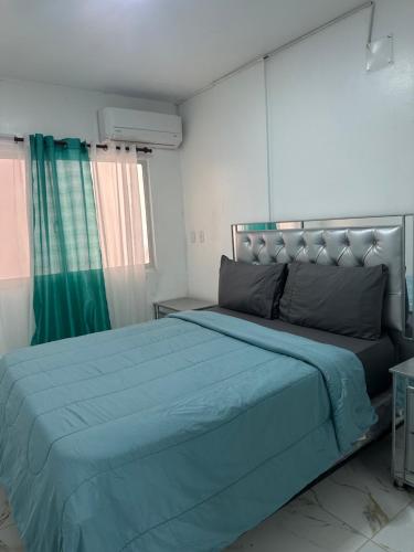 a bedroom with a large bed with a blue blanket at SahiR 2 in Cantabria