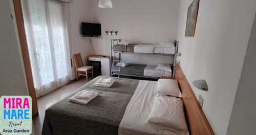 a bedroom with two bunk beds in a room at Miramare Resort in Rimini
