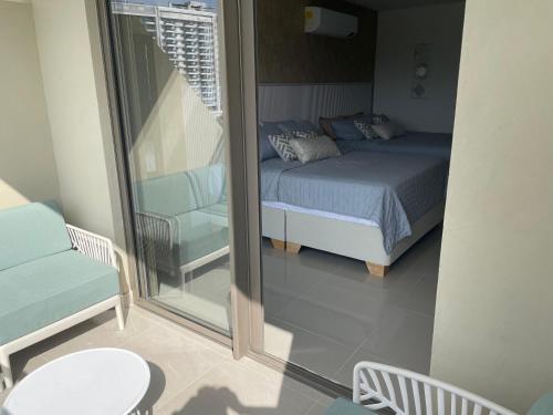 a bedroom with a bed and a balcony at Exclusive Rodadero Sur Studio Apartment in Santa Marta