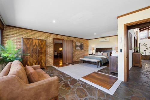 a living room with a couch and a bedroom at The Hills Opera House in Bickley