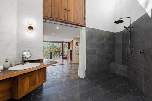 a bathroom with a sink and a shower at The Hills Opera House in Bickley