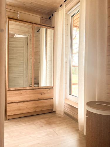 a room with a large window and a wooden floor at Serce Puszczy in Drawsko