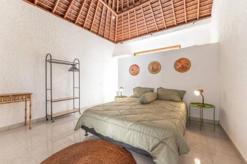 a bedroom with a large bed in a room at NEW Sawah Escape - Tropical 2BR with Pool and Views in Tabanan