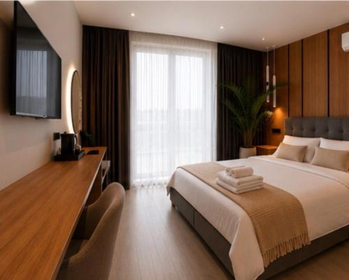 a bedroom with a large bed and a television at Апартаменти VIP in Ternopil