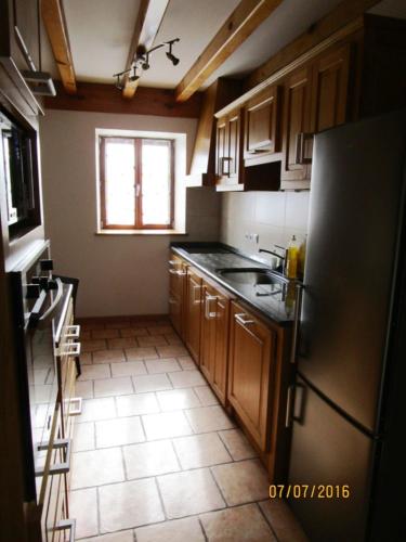 a kitchen with a refrigerator and a sink in it at Etxexuriko Borda in Aïnhoa