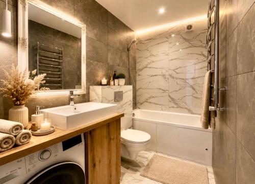 a bathroom with a sink and a toilet and a tub at Апартаменти VIP in Ternopil