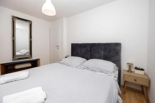 a bedroom with a large white bed with a mirror at Lux suite in Split- Jacuzzi&Gym&more in Solin
