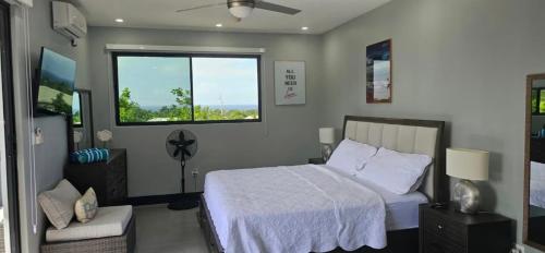a bedroom with a bed and a large window at Luxury Bliss in Runaway Bay