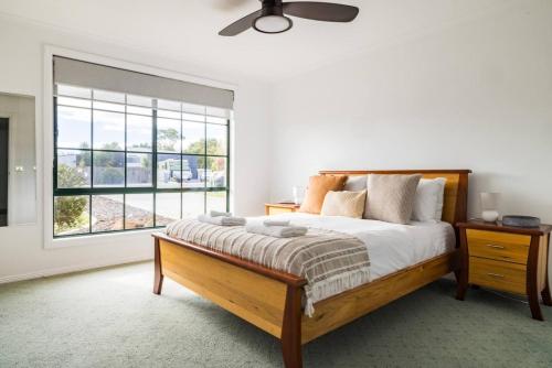 a bedroom with a bed and a large window at Nautilus Nest - Port Sorell in Port Sorell