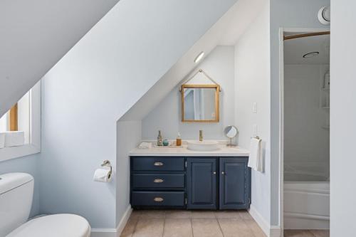 a bathroom with a blue cabinet and a sink at Oceanfront House Steps to Water in French Village
