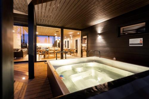 a large bath tub in the middle of a room at Stay North - Villa Mono in Pälkäne