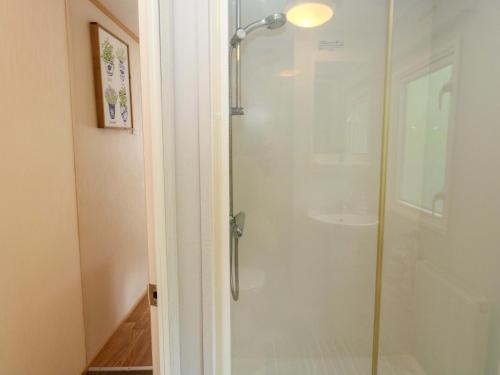 a shower with a glass door in a bathroom at Foxglove 4 in Ringwood