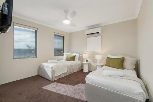 a white room with two beds and a couch at The Grand Aveley House in The Vines