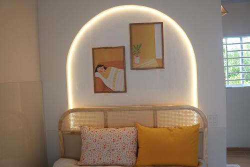 a bedroom with an archway above a bed with pillows at Tran Phu Riverside House in Can Tho