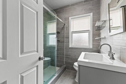 a bathroom with a sink and a toilet and a shower at 2 BR - Fully Equipped Dearborn Home in Dearborn