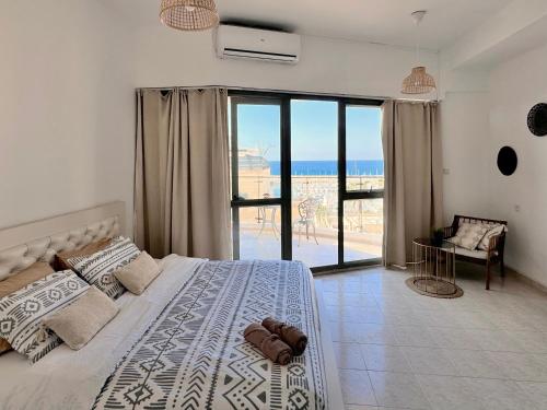 a bedroom with a bed and a view of the ocean at Marina View in Ashkelon