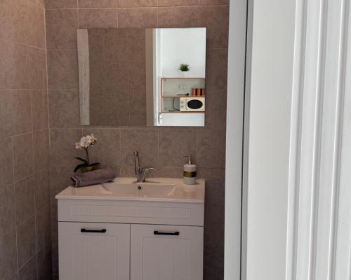 a bathroom with a sink and a mirror at Marina View in Ashkelon