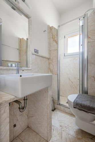 a bathroom with a sink and a toilet at Mimoza in Spetses
