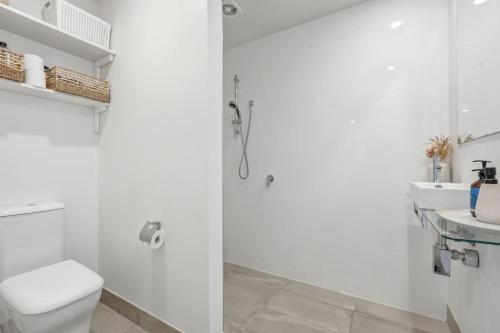 a bathroom with a shower and a toilet and a sink at Bush Escape with Water Views in Tinderbox