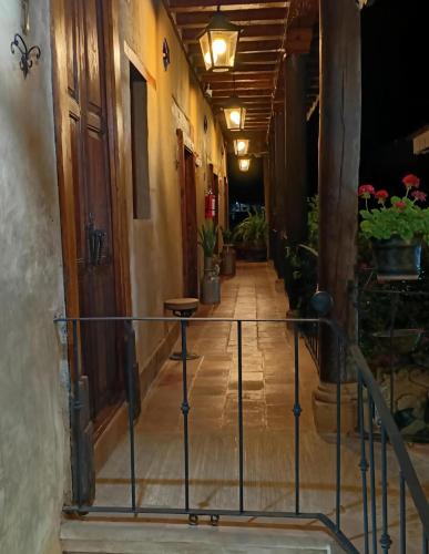 a hallway of a building with plants on it at Hotel Casa Cleo de Pátzcuaro in Pátzcuaro