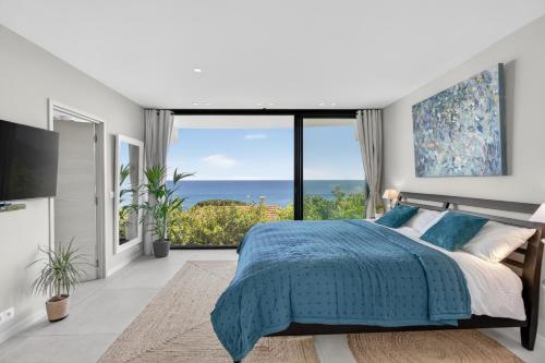 a bedroom with a bed and a view of the ocean at Villa Paradise in Éze