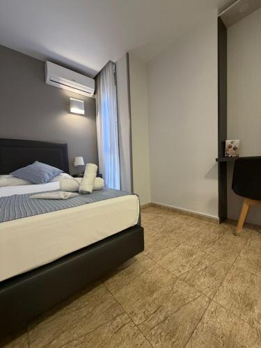 a bedroom with a bed and a chair and a window at Hotel Barajas Plaza in Madrid