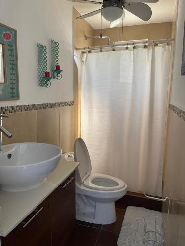 a bathroom with a toilet and a sink at Casa Aqua in Monterrico