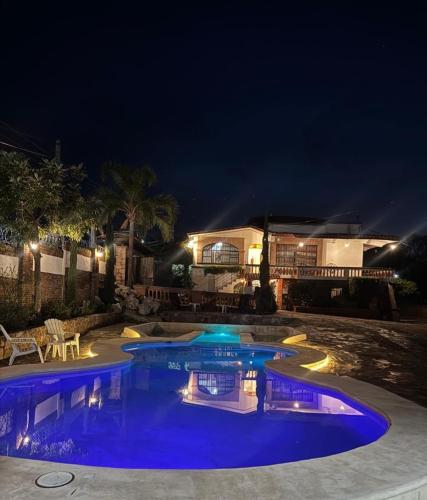 a pool at night with lights in a yard at Hotel Colonial Taxco in Taxco de Alarcón