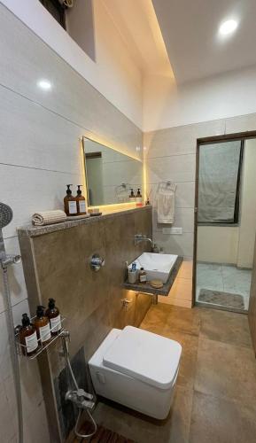 a bathroom with a toilet and a sink and a mirror at Hotel Surya Palace - Durg Railway Station in Durg