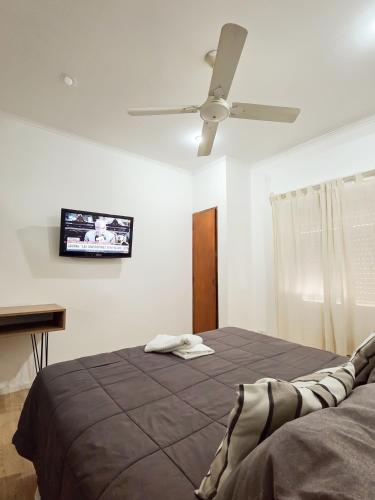 a bedroom with a bed and a ceiling fan at Hotel Milton in La Paz
