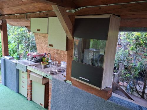 an outdoor kitchen with a counter and a sink at Plaža STEFIN KUTAK in Rudice
