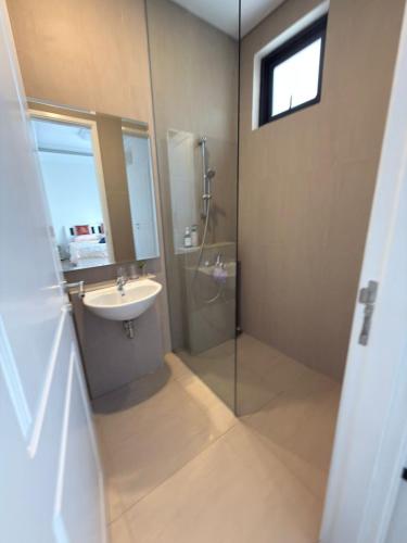 a bathroom with a glass shower and a sink at Noble Cove Batam in Pulau Sembakau Kecil