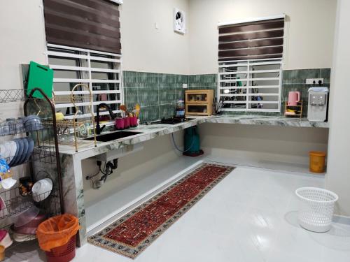 a kitchen with a sink and a counter at D'Jawa Homestay in Baling