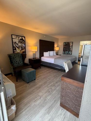 a hotel room with a bed and a chair at Extend-a-Suites Phoenix in Phoenix