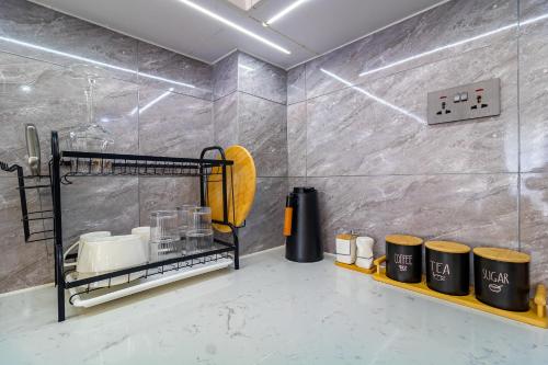 a kitchen with a counter with appliances on a shelf at Luxury 1 bedroom in Westlands, Rooftop Pool, Next to Kempinski & GTC, Fast Wifi & Pool Table in Nairobi