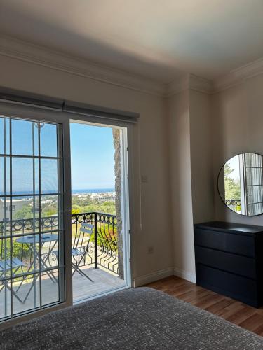 a bedroom with a view of a balcony at Hillside Villa with Sea Views in Kyrenia