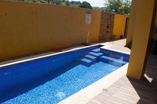 a large blue swimming pool next to a building at The Vista Inn Studio #2 in Falmouth
