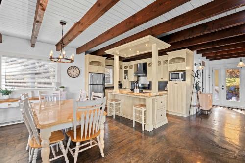 a kitchen and dining room with a table and chairs at Waterfront with VIEW and SPA in Saint-Raymond
