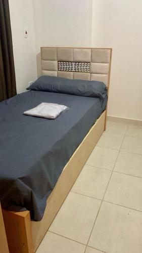 a bedroom with a bed with a blue comforter at Biu Bela abartment hotel in El Alamein