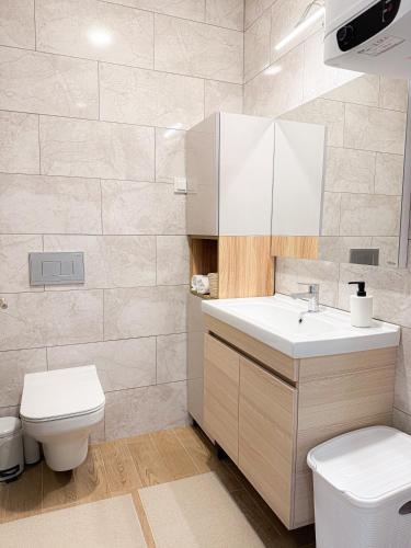 a bathroom with a white sink and a toilet at JoHa Stay in Bar