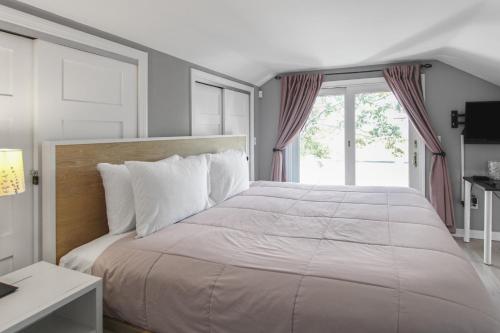 a bedroom with a large bed and a window at The Viewpoint in Provincetown