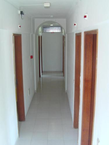 a hallway of a room with two doors at Residencia do Parque in Odeceixe