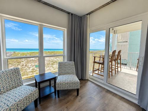 a living room with a view of the ocean at Perdido Key Beachfront 4BR Sleeps 12 Steps to the Beach Sweeping Gulf View in Pensacola