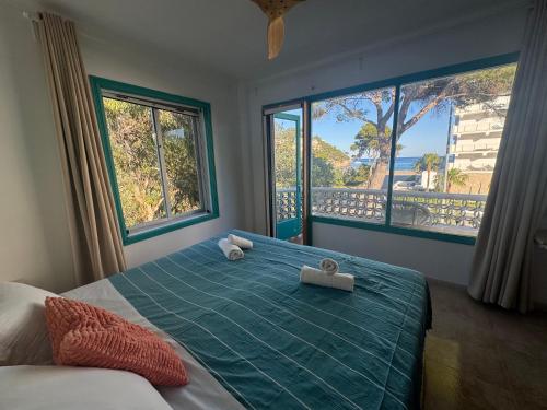 a bedroom with a bed with two towels on it at Es Raco de Canyamel in Canyamel
