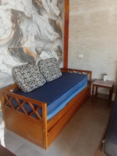 a bed with two pillows on it in a room at Suites perto praia in Ubatuba
