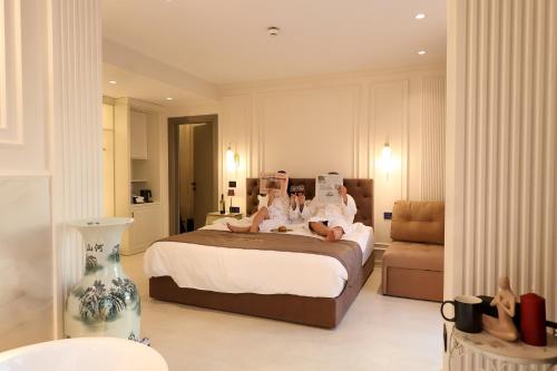 a bedroom with two people laying on a bed at Licorne Suites in Tirana
