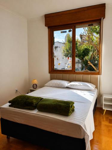 a bedroom with a large bed with a window at Villa Serena, próx do Aeroporto in Porto Alegre