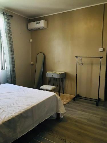 a bedroom with a bed and a mirror on the wall at cozy home in Argy