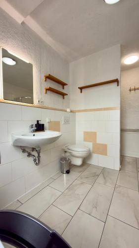 a bathroom with a sink and a toilet at Construction worker's apartment in Hof in Hof