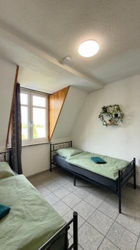 a bedroom with two beds and a window at Construction worker's apartment in Hof in Hof